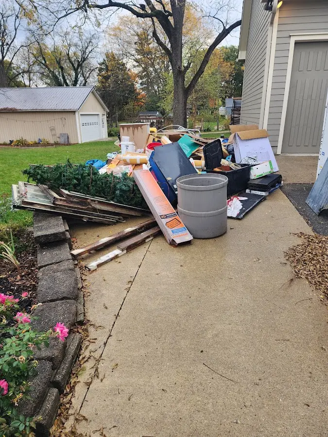 Dumpster being loaded with debris for 12 Yard Dumpster Rental in Elkton